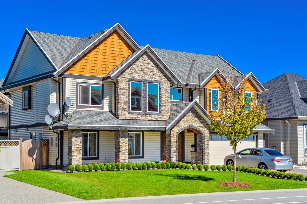 Large two story home with decorative stone siding.