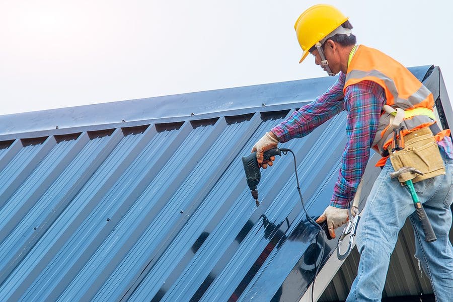 Man working on installing a metal roof installation process
