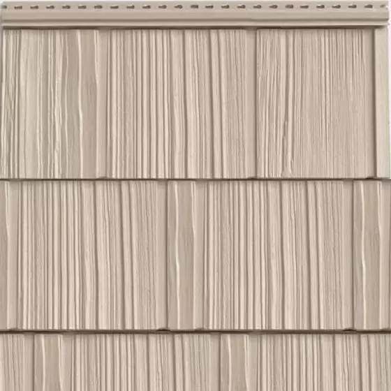 Close-up of textured vinyl imitation shake siding in a beige tone, designed to mimic the rustic charm of natural cedar shake. This durable siding option by Wagner is ideal for accent areas, offering a timeless aesthetic with low-maintenance resilience against the elements.